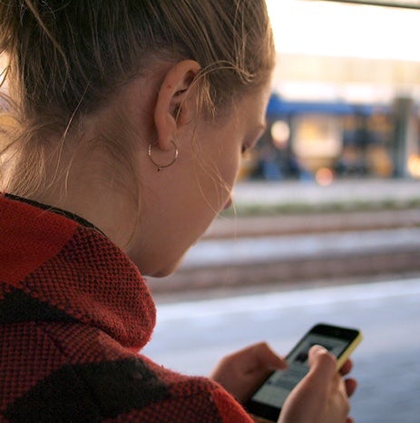 Side profile of a woman on a smartphone