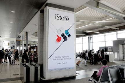 Digital Astral board featuring an iStore ad inside a gate of Ottawa's airport
