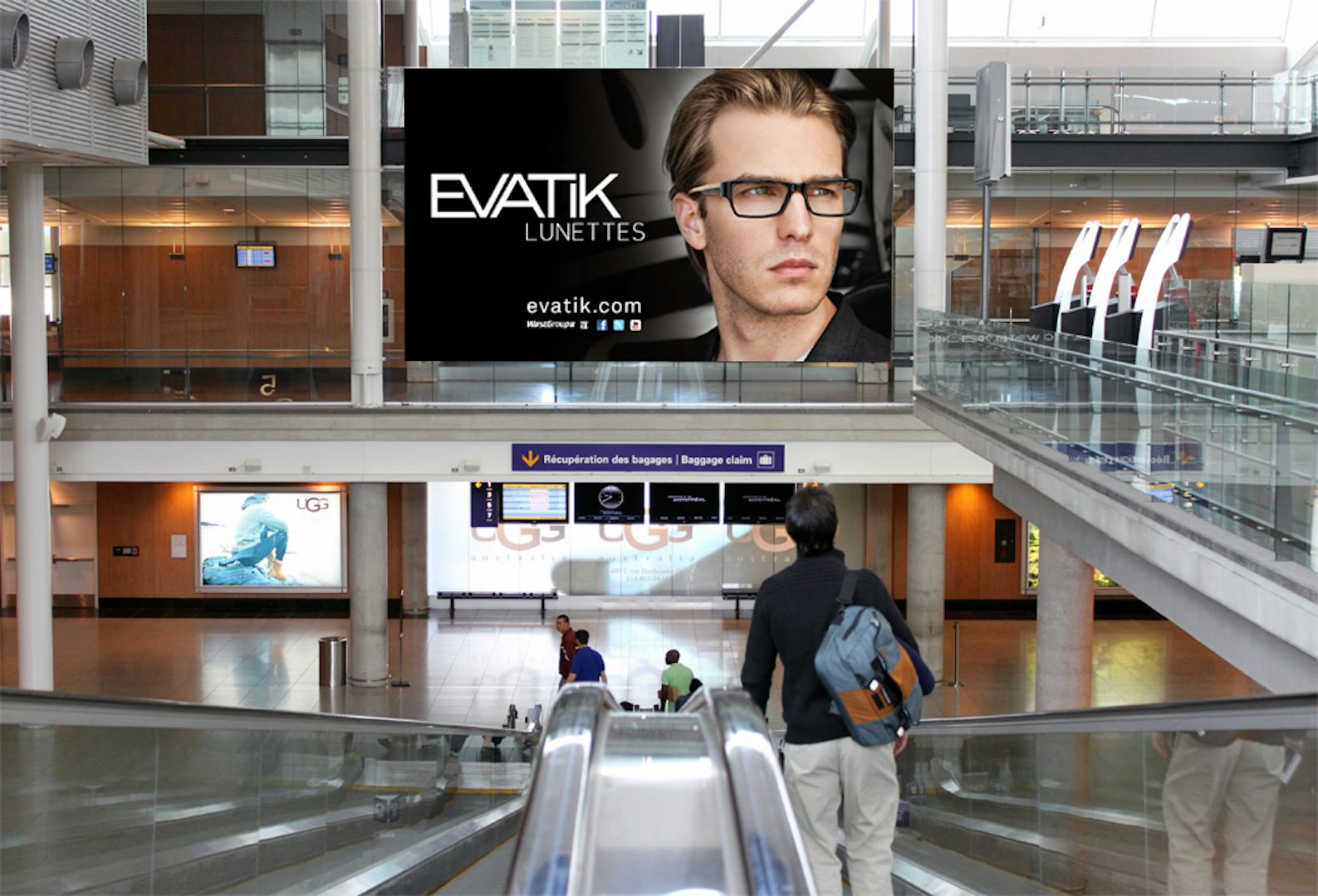 Digital Astral board above an escalator in Montreal airport featuring an Evatik ad