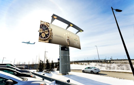 Large format Astral board outside Montreal airport featuring a Rolex ad