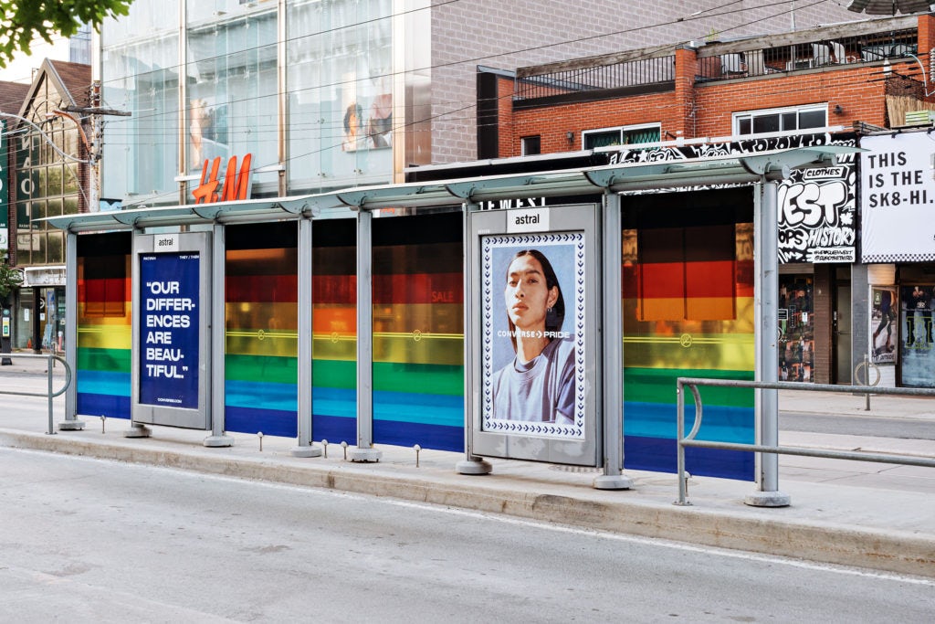 Astral transit shelter featuring a Converse ad and rainbow-tinted glass