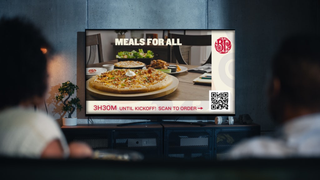 Boston Pizza ad in TV screen with QR code - showcasing e-commerce solutions