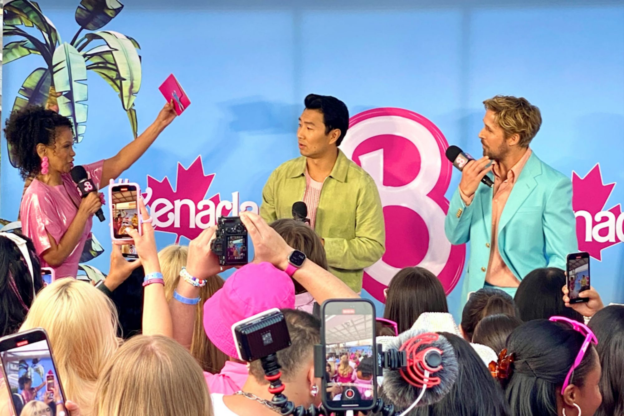 Traci Melchor interviewing the cast of Barbie with fans taking photos