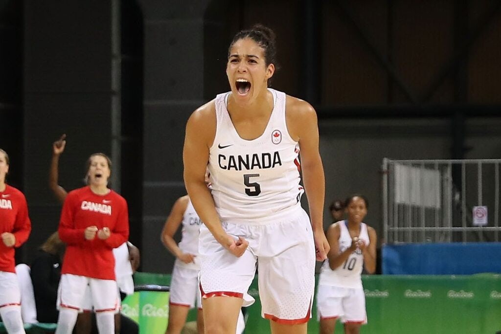 Kia Nurse cheering with her team in the background