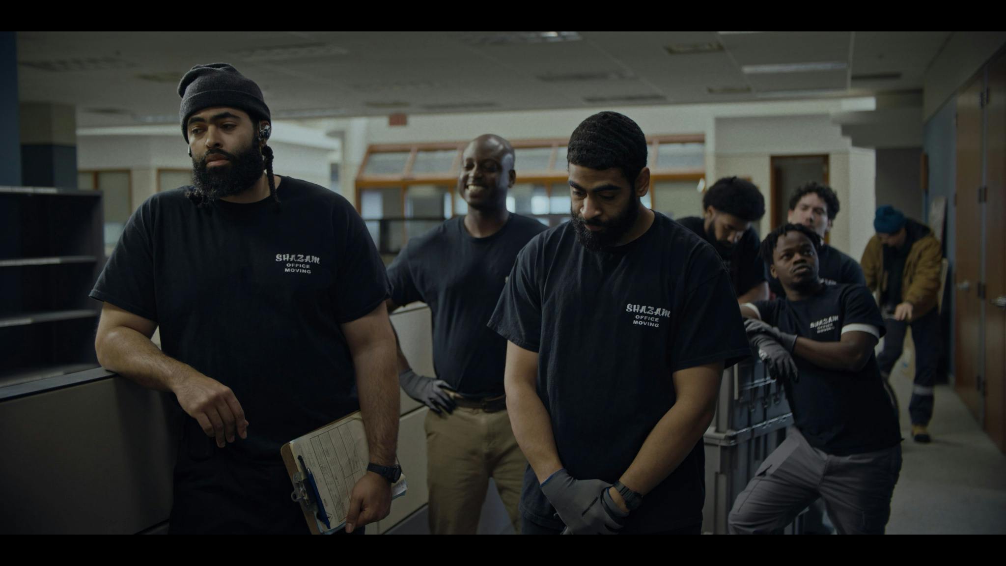Everett and Eric Saunders with their crew standing in an office at The Office Movers.
