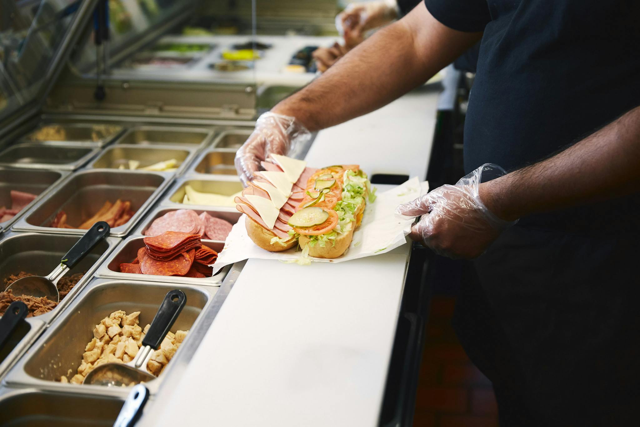 Employee preparing a sandwich