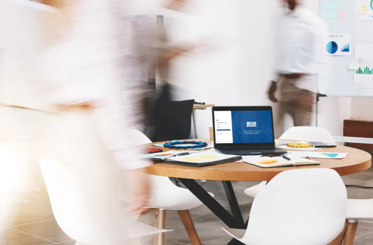blurry people beside a computer screen